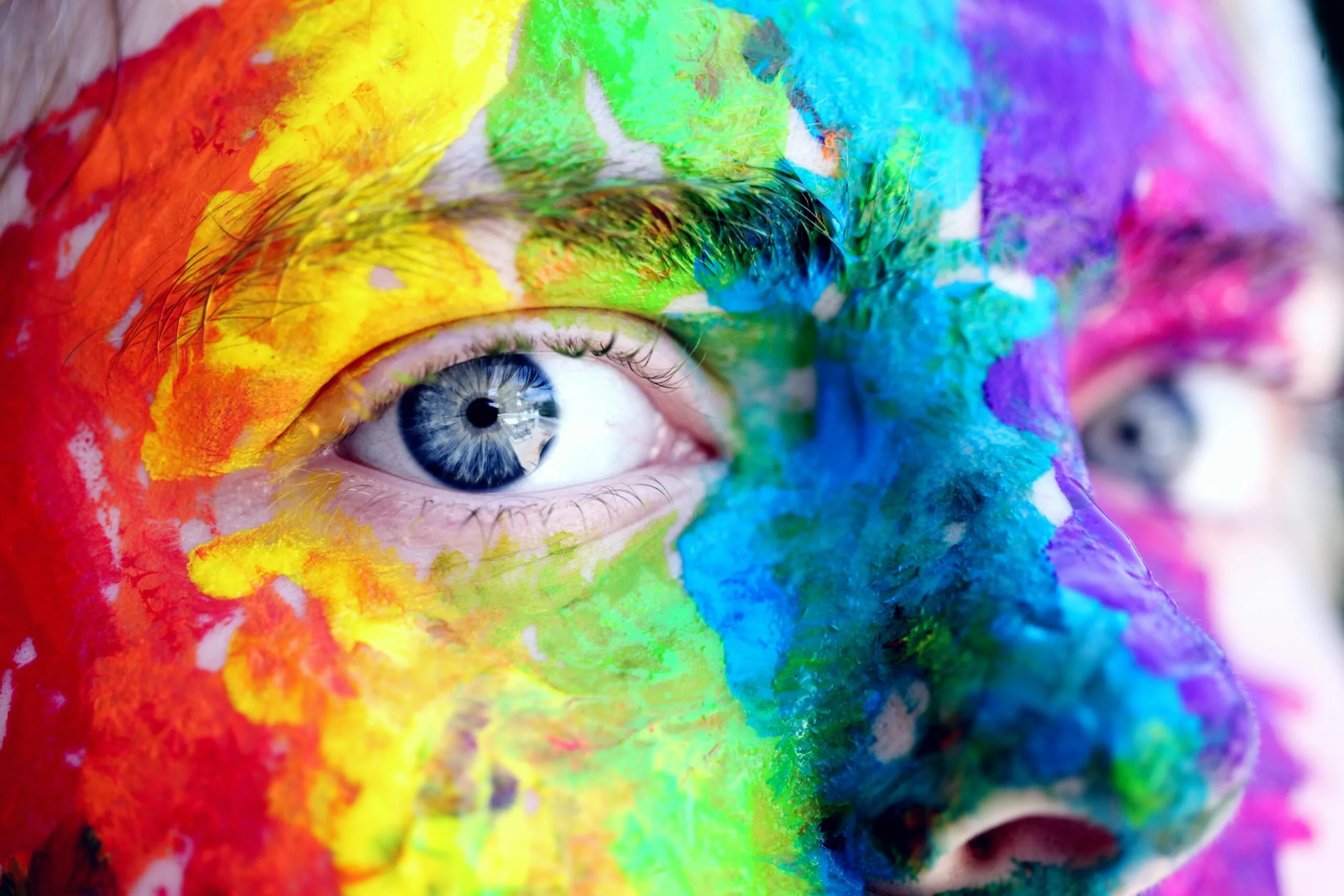 Close-up of a person with colorful rainbow face paint